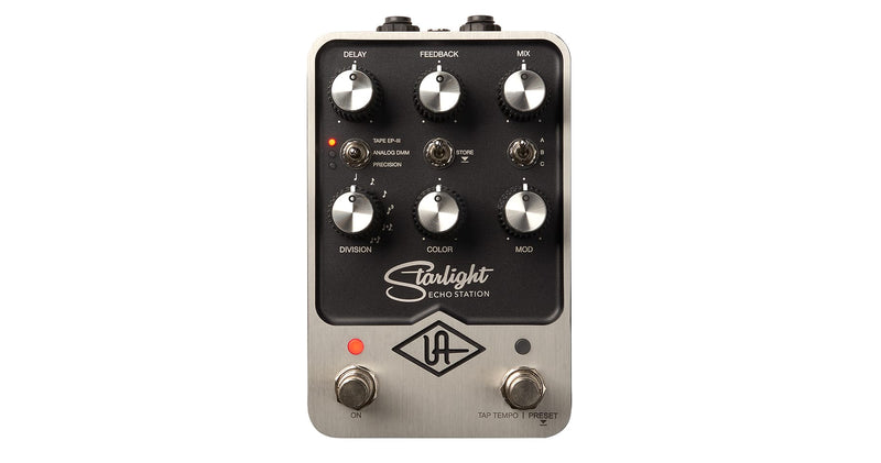 A black and silver Universal Audio Starlight Delay Pedal with a knob on it, featuring UAD modeling expertise.