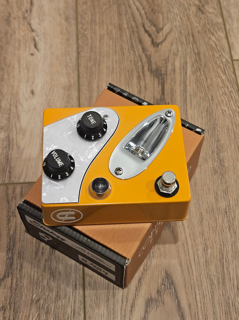 A CopperSound Strategy V2 Two Channel Preamp & Overdrive Capri Orange CUSTOM BUILD guitar pedal sitting on a wooden floor by CopperSound Pedals.