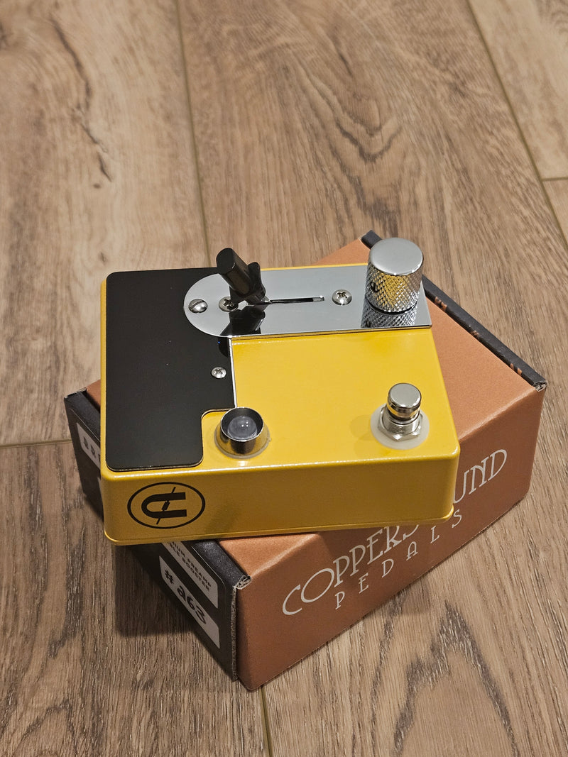 A CopperSound Broadway Treble Booster & Germanium Preamp Butterscotch CUSTOM BUILD pedal sitting on a wooden floor.