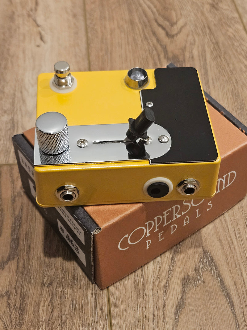 A CopperSound Broadway Treble Booster & Germanium Preamp Butterscotch CUSTOM BUILD pedal sitting on a wooden floor.