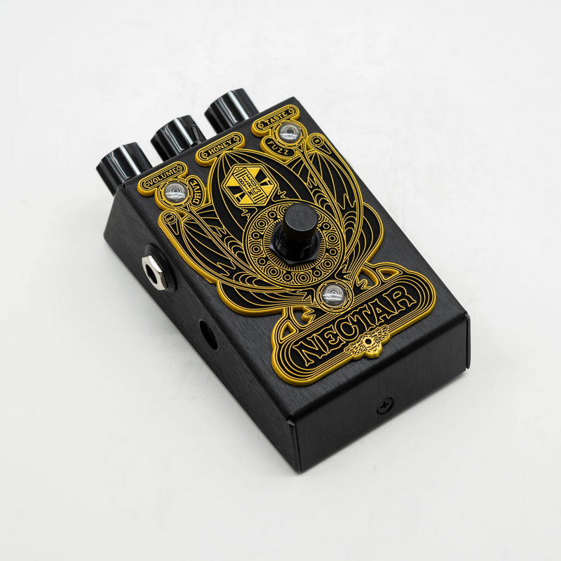 A versatile black and gold pedal adorned with a skull, offering simplicity in design for optimal tone sweetening with Beetronics FX Nectar Tone Sweetener Overdrive Distortion Fuzz.