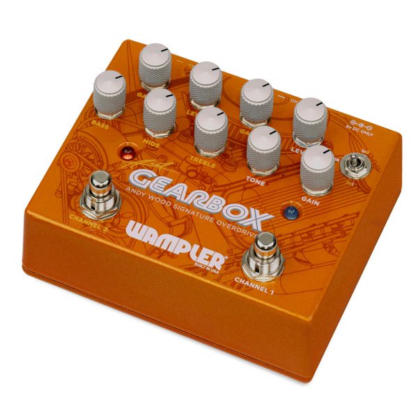 A guitarist's essential Wampler Gearbox Andy Wood Signature Overdrive pedal, boasting four knobs, perfect for refining their electric guitar skills and achieving the desired sound for their album.