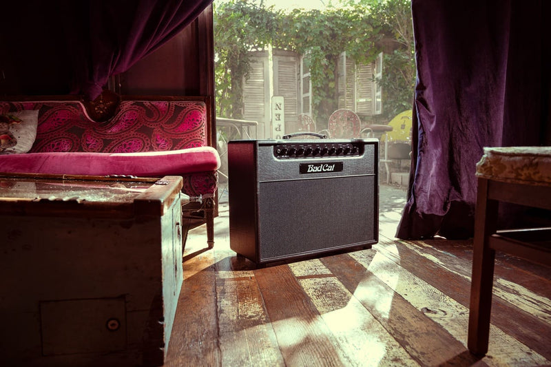 A Bad Cat Jet Black guitar amplifier sitting on a wooden floor, providing the perfect volume and tones for any musical performance.